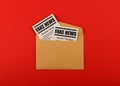 Envelope with FAKE NEWS newspapers over red