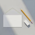 Envelope with flap open, white in color. Beside it, a yellow graphite pencil with pink Royalty Free Stock Photo