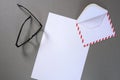 Envelope, glasses and a letter on a grey background Royalty Free Stock Photo