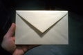 Envelope held in a hand showcasing simplicity and anticipation of its contents during a quiet evening Royalty Free Stock Photo