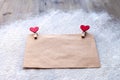 The envelope of Kraft paper with two red clothespins in the shape of hearts, Valentine`s day, people`s attitudes