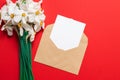 The envelope layout and frame of red tulips on a red background. Flat lay with copy space Royalty Free Stock Photo