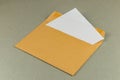Envelope with a letter partially pulled out on a neutral surface Royalty Free Stock Photo