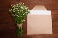 envelope made of craft paper, next to a bouquet of chamomile flowers Royalty Free Stock Photo