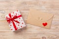 Envelope Mail with Red Heart and gift box over Orange Wooden Background. Valentine Day Card, Love or Wedding Greeting Concept Royalty Free Stock Photo