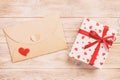 Envelope Mail with Red Heart and gift box over Orange Wooden Background. Valentine Day Card, Love or Wedding Greeting Concept Royalty Free Stock Photo