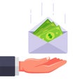 an envelope with money falls into the hand.