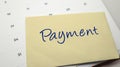 Envelope with Paymen written in blue ink placed on a calendar background Royalty Free Stock Photo