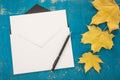 Envelope, pen and autumn leaves Royalty Free Stock Photo