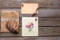 Envelope, postcard and mask on a wooden background.