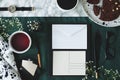 Envelope, postcard, tea, pen, quill, glasses, watch and cake on a desk. Top view