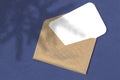 Envelope with a sheet of paper on a blue background. Layout with the imposition of the shadow of the Christmas tree