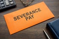 Envelope with sign severance pay on the desk. Royalty Free Stock Photo
