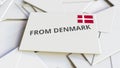 Letter with From Denmark text on pile of other Letters. International mail related conceptual 3D rendering