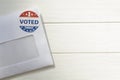 Envelope with voting ballot papers sent by mail for absentee vote in presidential election. Top view with copy space Royalty Free Stock Photo