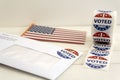 Envelope with voting ballot papers sent by mail for absentee vote in presidential election, USA flag and I voted today stickers