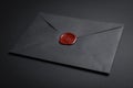 Envelope with wax seal on black background