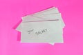 Envelope with word your SALARY isolated on pink background