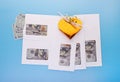 Envelopes with dollar bills and golden gift box on blue background, top view with copy space. Business bonus, donation, corruption Royalty Free Stock Photo