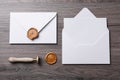 Envelopes with wax seal and stamp on wooden table, flat lay Royalty Free Stock Photo