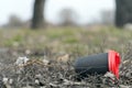 Enviromental pollution; paper cup for coffee on a background of forest nature and grass.