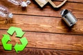 Environment concept with recycling symbol on wooden background top view mock up Royalty Free Stock Photo