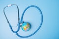 Environment, ecology, planetary health, globe planet and stethoscope on blue background