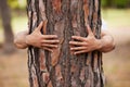 Environment, hands and man hug trees for save the planet, nature deforestation or community support project. Earth day