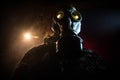 Gas mask with clouds of smoke on a dark background. Sign of radioactive contamination. Means for radiation protection. Danger of Royalty Free Stock Photo