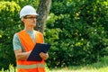 Environmental engineer man in the forest notes the environmental situation. Royalty Free Stock Photo