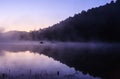 Environmental Friendly Outdoor Activity, Floating Bamboo Rafting in the morning in serene lake with sunlight and mist water