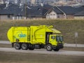 An environmental management 360 Solutions Ltd yellow truck during early spring on the