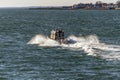 Environmental Police patrol boat sending up spray during fast ride