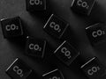 Environmental pollution and carbon emission concept. CO2 carbon dioxide symbol on black cubes Royalty Free Stock Photo