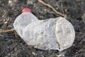 An empty plastic bottle of water, left as trash over the ground Royalty Free Stock Photo