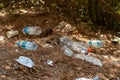 Environmental pollution. Plastic bottles and a protective mask thrown on the floor in the woods. Royalty Free Stock Photo