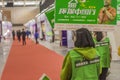 Building Materials Exhibition A merchant employee holds up a green billboard to promote green panels Royalty Free Stock Photo