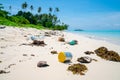 Environmental trash disgarded on idyllic beach