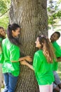 Environmentalists standing around tree trunk Royalty Free Stock Photo
