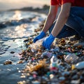 Environmentally conscious woman cleaning up trash on a sandy beach during a breathtaking sunset