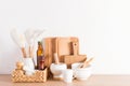 Environmentally friendly items of modern utensils on a kitchen wooden countertop near a white textured wall. eco-friendly Royalty Free Stock Photo