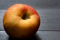 The envy apple on black wooden board after bring out of the refrigerator