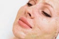 Enzyme mask in the process of drying on a woman`s face close-up. Rejuvenation and facelift in cosmetology