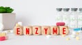 enzyme word written on wooden blocks and stethoscope on light white background. High quality photo Royalty Free Stock Photo