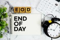 EOD End of Day text with calculator and alarm clock on marble background Royalty Free Stock Photo