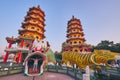 Eople come to merit at Cih Ji Dragon and Tiger Pagodas on lotus pond in sunset time
