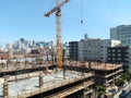 people and Crane works at High-rise Construction site high up in San Francisco