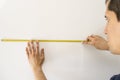 Eople pointing at a measuring tape on the wall Royalty Free Stock Photo