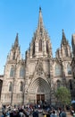 Eople walking near The Cathedral of the Holy Cross and Saint Eulalia, also known as Barcelona Cathedral in the Gothic quarter of B