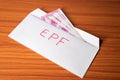 Epf money inside the envelope at table - concept of investment, employment benefit and growth Royalty Free Stock Photo